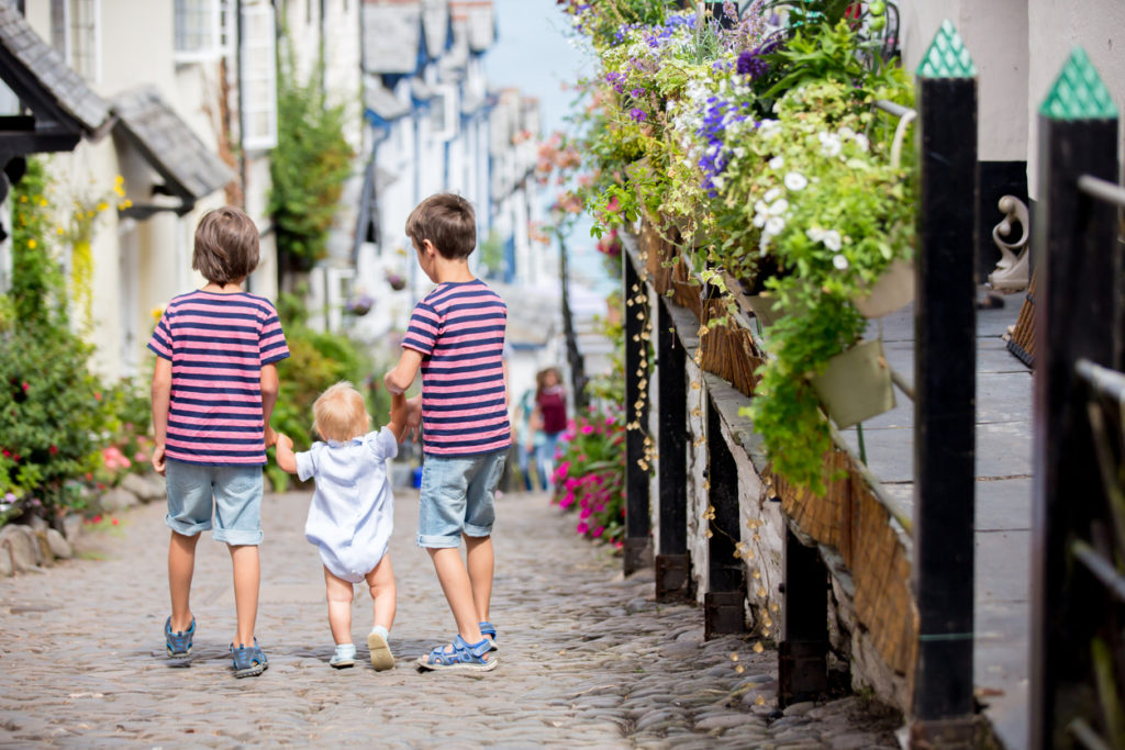 Beautiful family, walking on the streets of Clovelly, nice old village in the heart of Devonshire, England