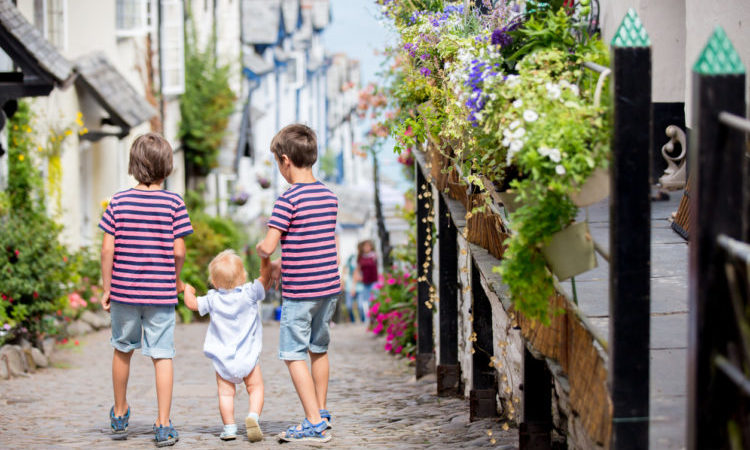 Beautiful family, walking on the streets of Clovelly, nice old village in the heart of Devonshire, England