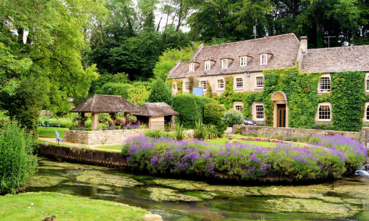 Picturesque garden in the Cotswold village of Bibury, England